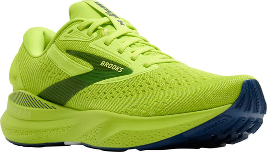 Green running shoe with blue sole on a white background