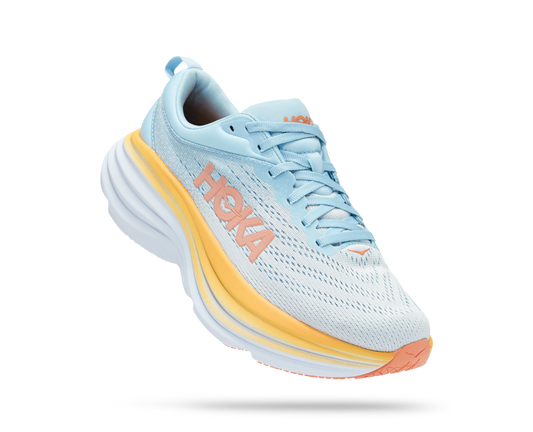 Hoka running shoe with light blue/grey fabrics and orange and white sole.
