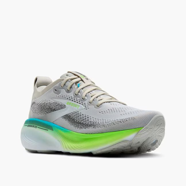 Gray running shoe with green sole on a white background