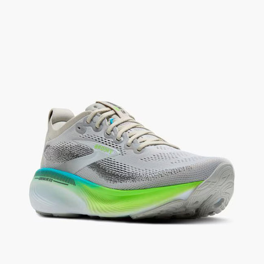 Gray running shoe with green sole on a white background