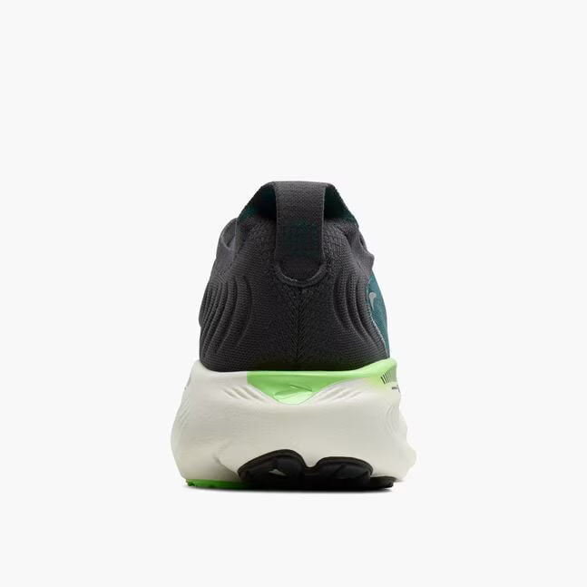 Back view of a black and white sneaker with green accents on a white background