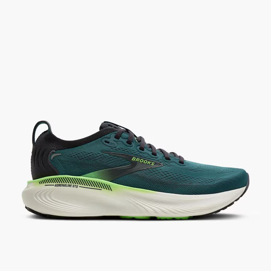 Green running shoe with white sole on a light gray background
