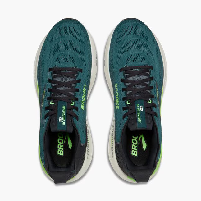 Pair of teal running shoes with black and green accents on a white background