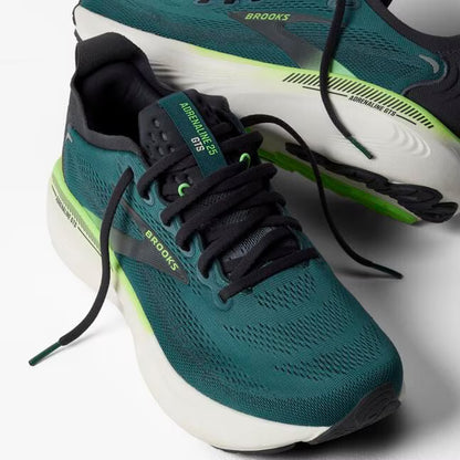 Teal running shoe with black laces on a light gray background