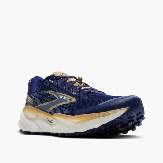 Navy and beige running shoe with 'Brooks' branding on a white background