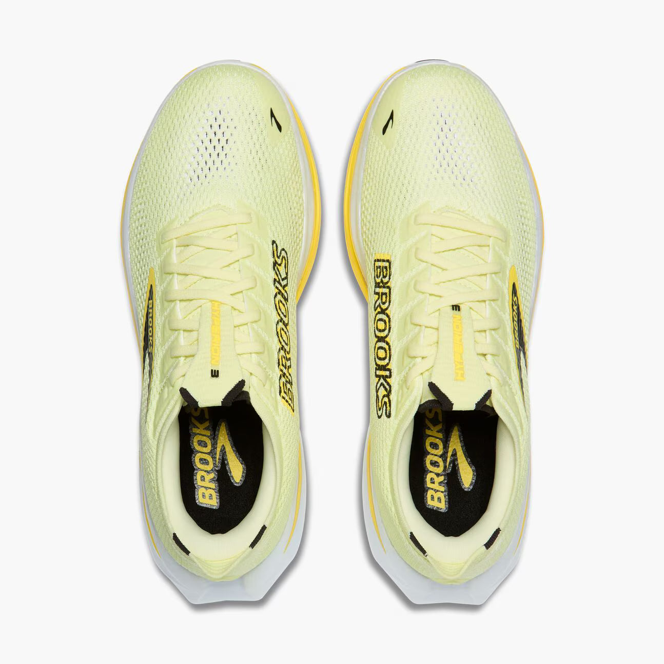 Pair of yellow running shoes with 'Brooks' branding on a white background
