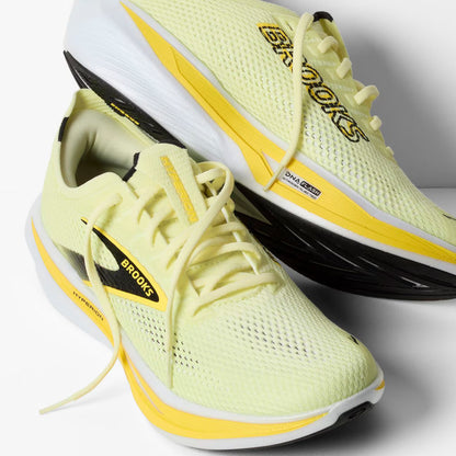 Light yellow running shoe with yellow sole and Brooks logo on a white background