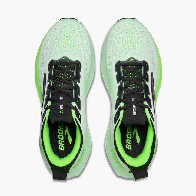 Pair of green and black running shoes with 'Brooks' branding on a white background