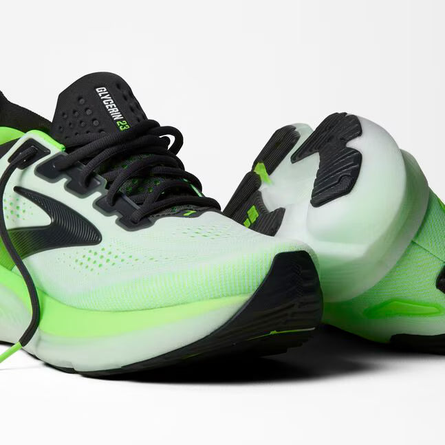 Neon green and black athletic shoes on a white background