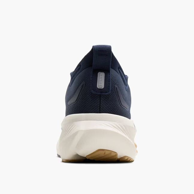 Navy running shoe with white sole on a white background