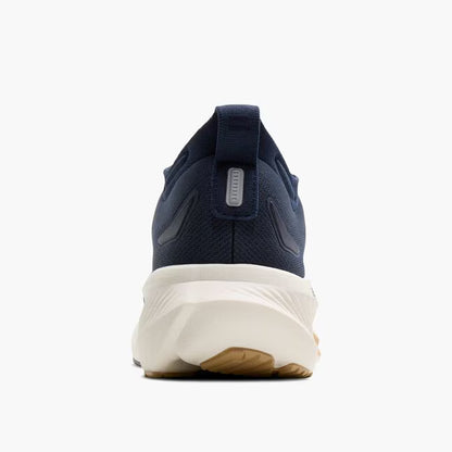 Navy running shoe with white sole on a white background