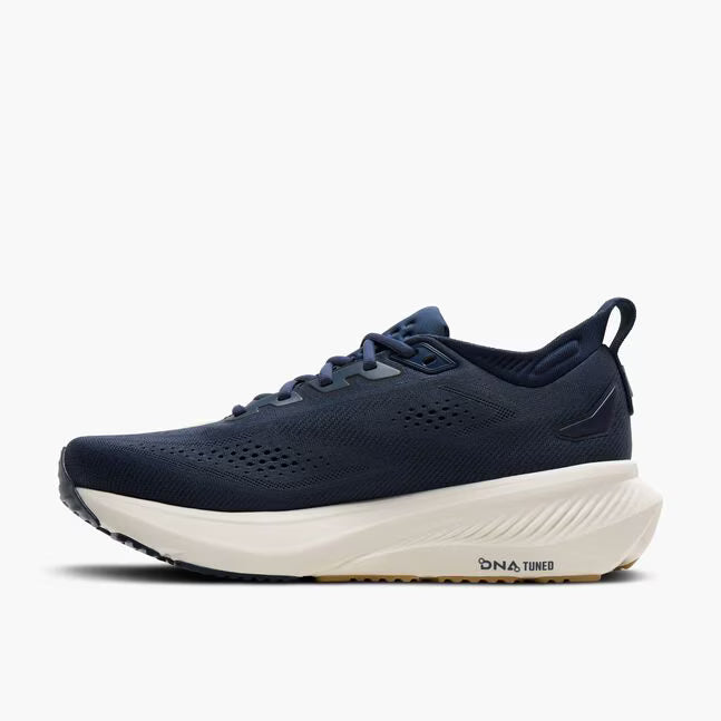 Navy running shoe with white sole on a white background