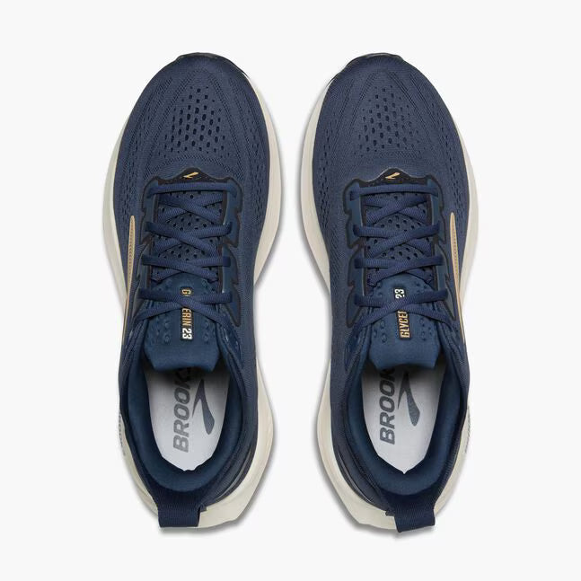 Pair of blue running shoes with white soles on a white background