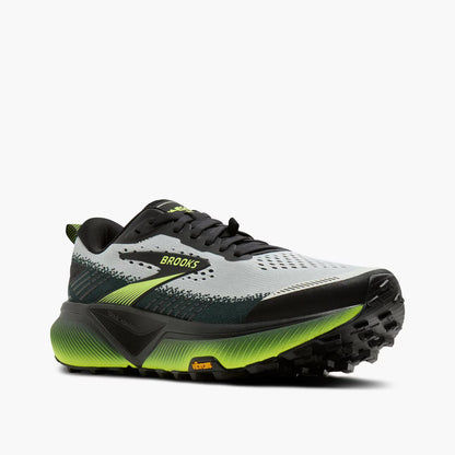 Brooks trail running shoe in light gray and black with bright neon yellow-green accents on the midsole and logo, shown from a side profile on a light gray background.