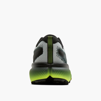 Back view of a black and green athletic shoe on a white background