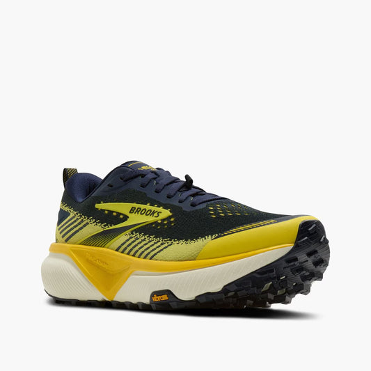 Brooks Cascadia 20 running shoe in navy blue, yellow, and white, shown from a side profile on a light gray background.