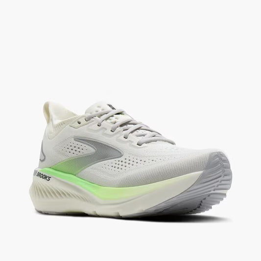 White running shoe with green sole on a white background