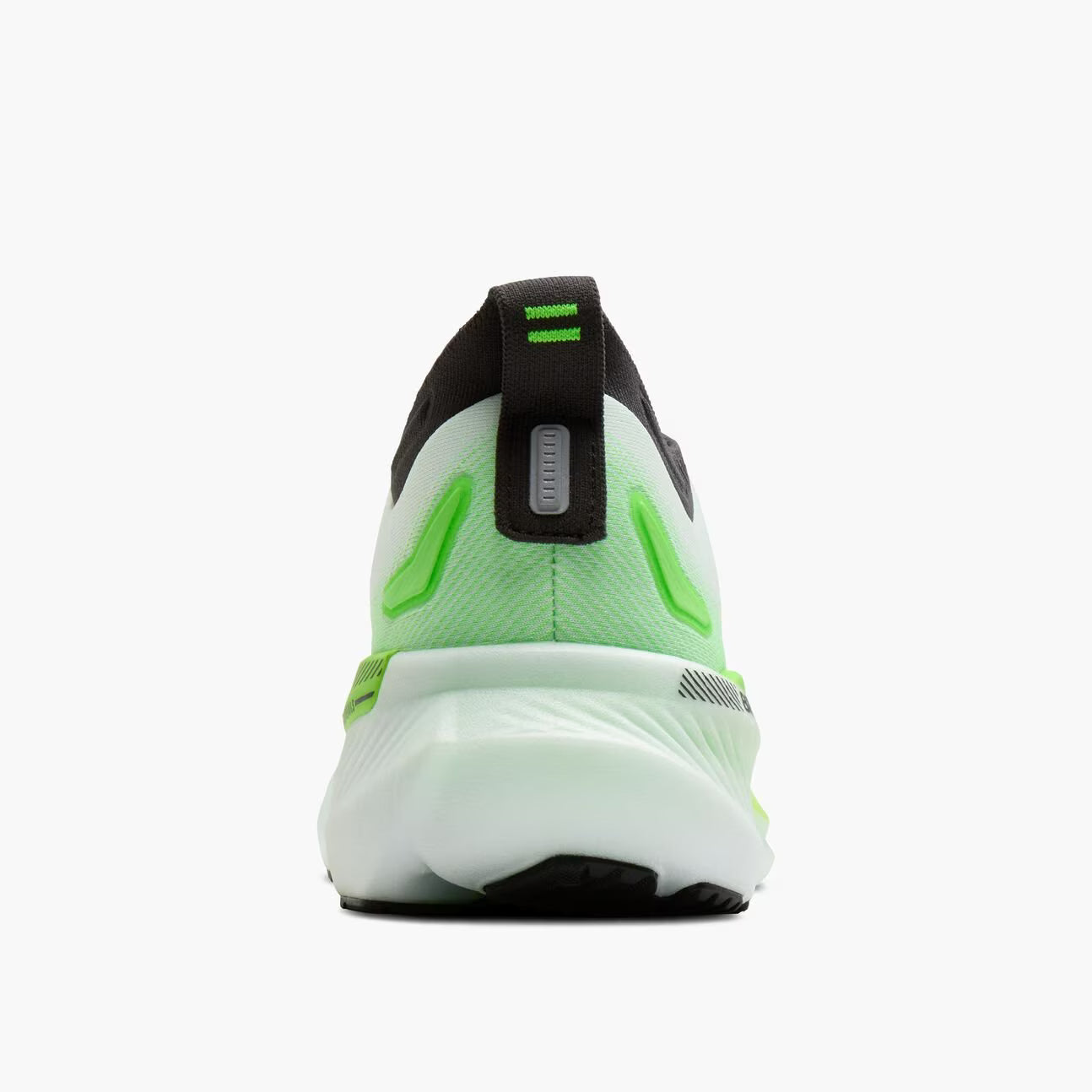 Back view of a running shoe with green and black design on a white background