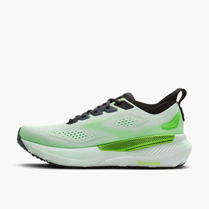 Green and white running shoe on a white background