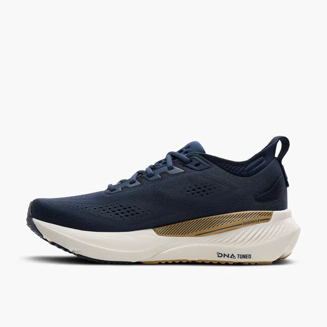Navy running shoe with white sole on a light gray background