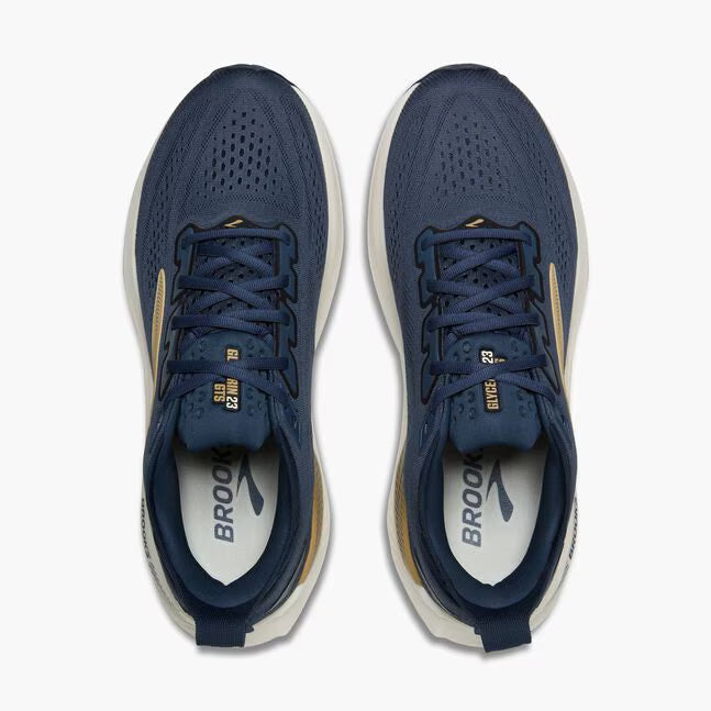 Pair of blue running shoes with white soles on a white background