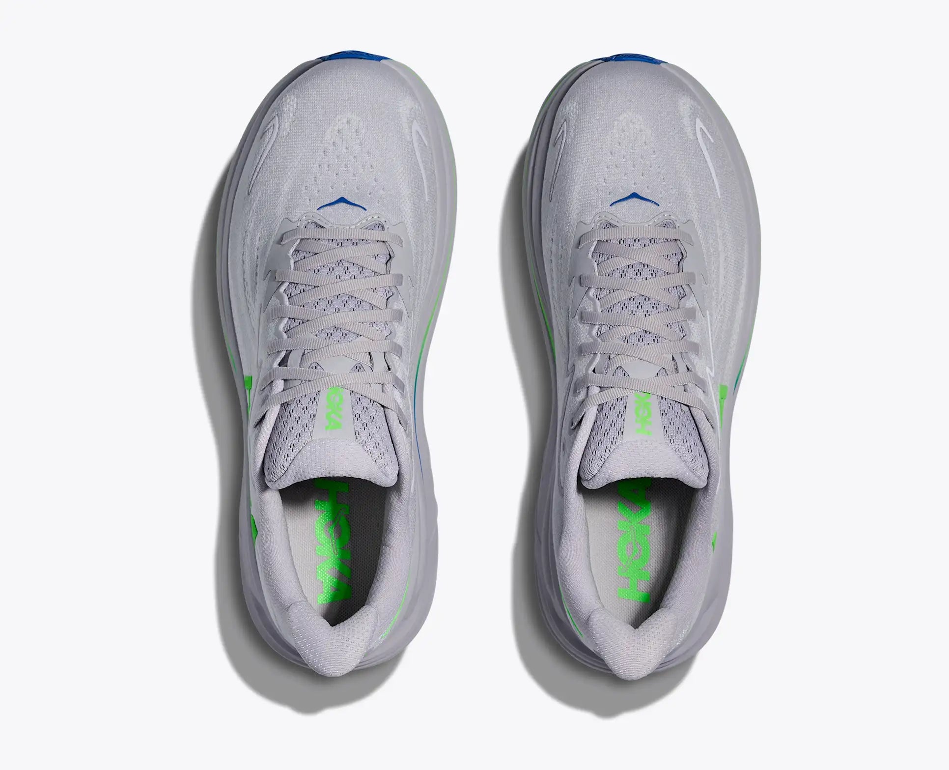 Pair of gray Hoka Men's Clifton 10 sneakers with green accents on a white background