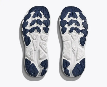 Close-up of white and blue athletic shoe soles on a light gray background