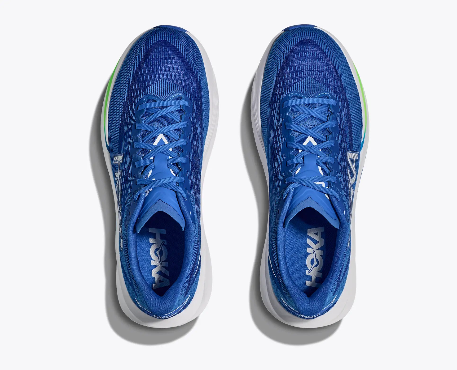Blue running shoes with white soles on a light gray background