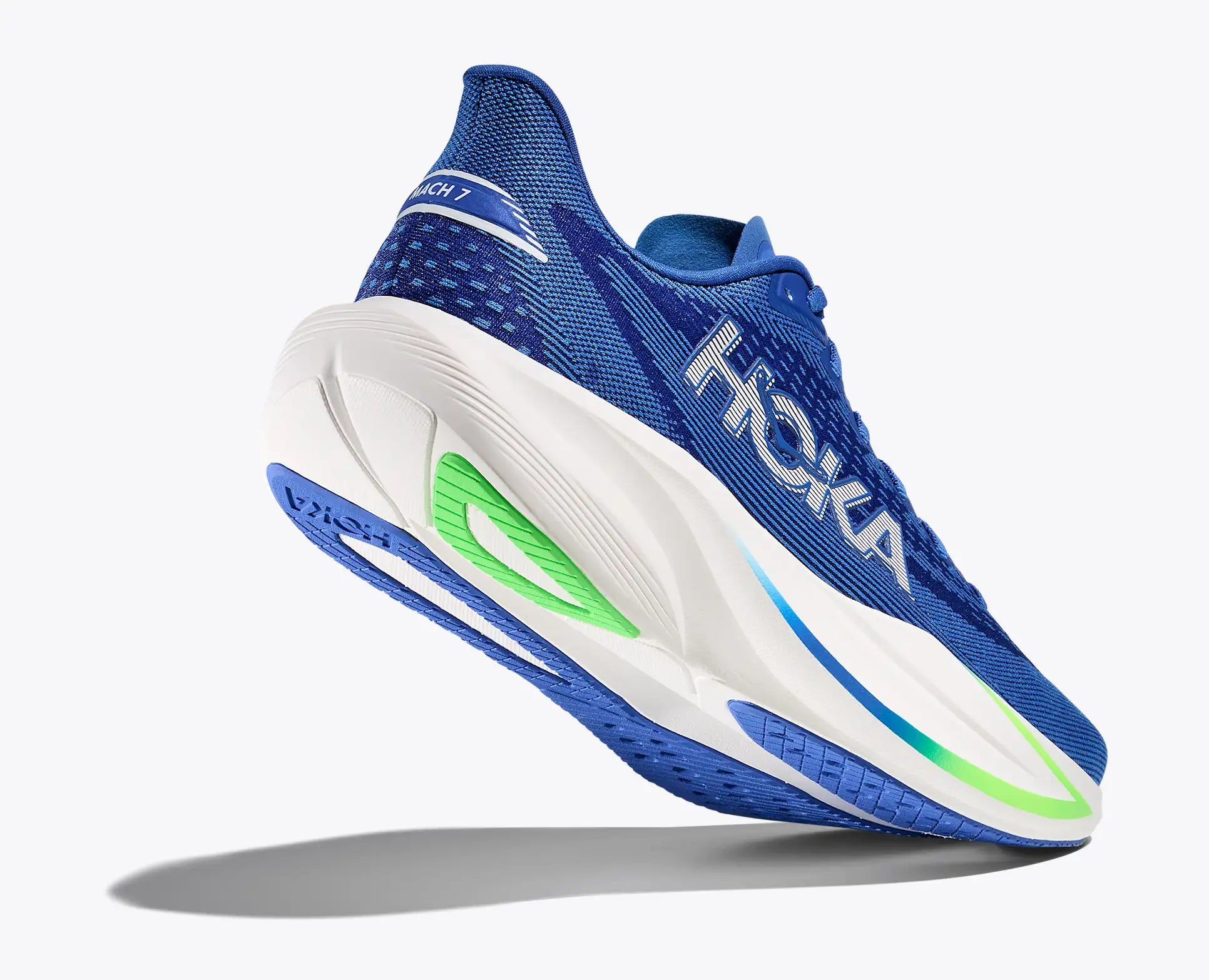 Blue and white running shoe with green accents on a light gray background