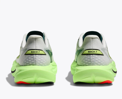 Pair of running shoes with bright green soles on a white background