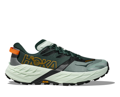 Green running shoe with orange accents on a white background