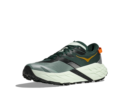 Green and white running shoe with a visible brand logo on a white background