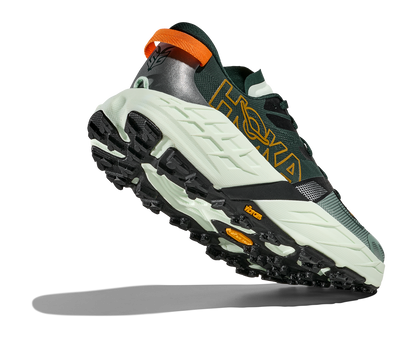 Green and black sneaker with orange accents on a white background