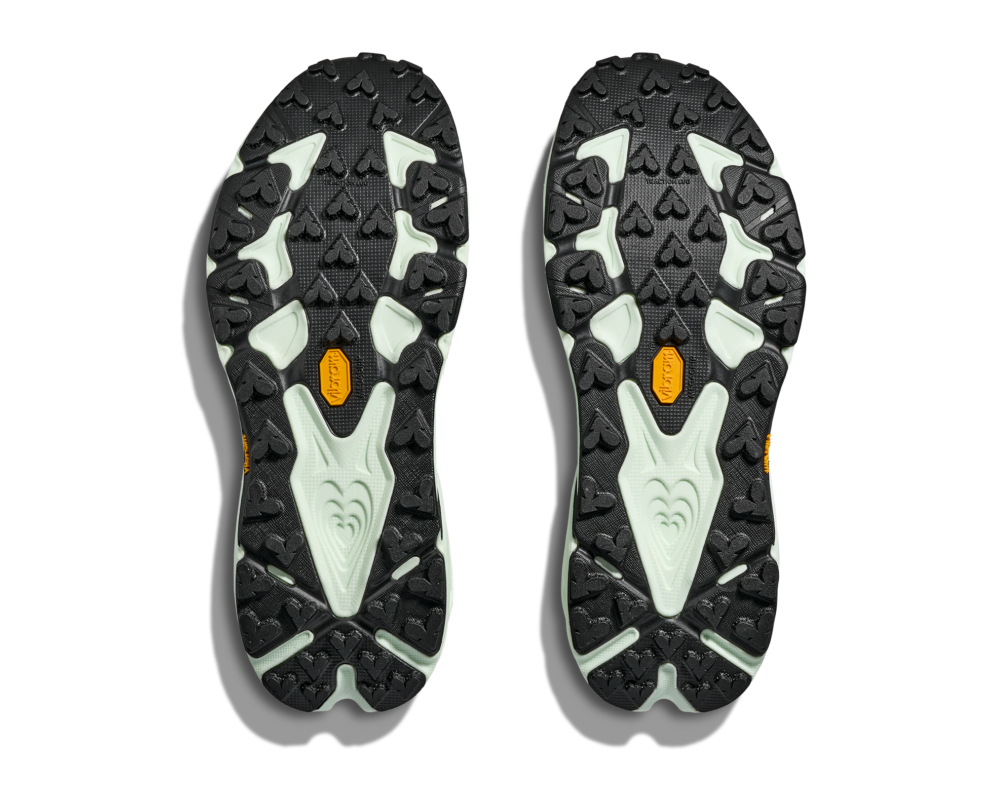 Close-up of black and gray shoe soles with orange accents on a white background