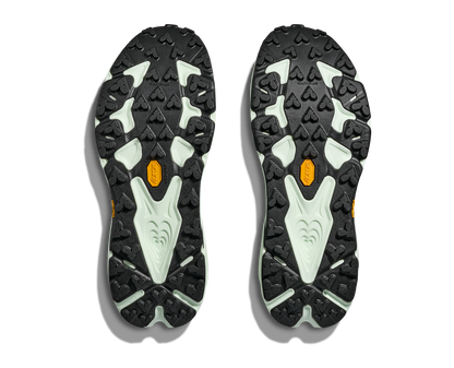 Close-up of black and gray shoe soles with orange accents on a white background