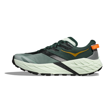 Green and black running shoe with orange accents on a white background