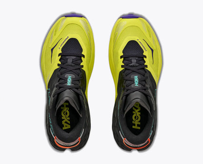 A pair of Hoka Men's Speedgoat 7 running shoes shown from a top-down view, featuring a bright neon yellow and black design with small purple and orange accents.