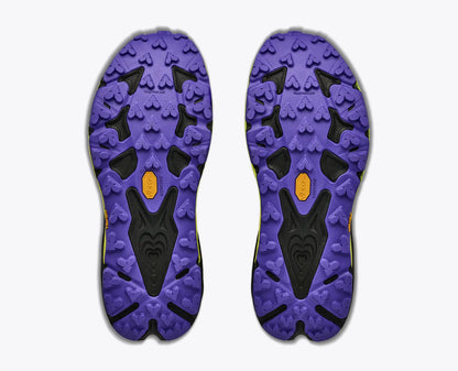 The outsoles of a pair of Hoka Men's Speedgoat 7 purple and black athletic shoes, showing the tread pattern and Vibram logo, on a light gray background.
