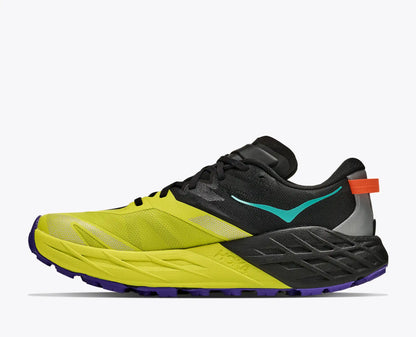 A Hoka Men's Speedgoat 7 trail running shoe in bright yellow, black, and teal, with a small orange pull tab on the heel, shown from a side profile on a light gray background.
