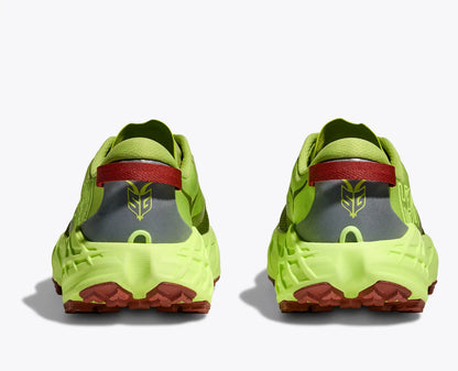 Pair of bright green athletic shoes with red and gray accents on a white background