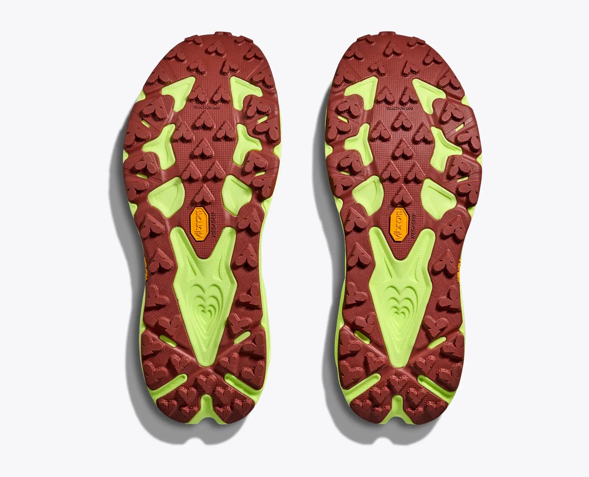 Close-up of red and green shoe soles on a white background