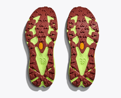 Close-up of red and green shoe soles on a white background
