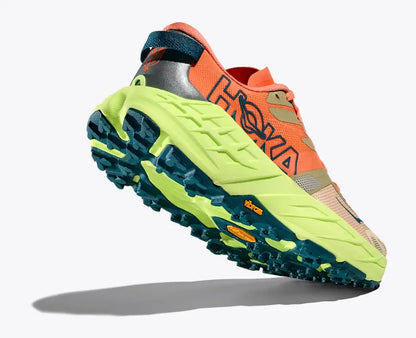 Orange and green trail running shoe with unique sole design on a white background