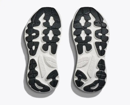 Close-up of a pair of black and white shoe soles on a light gray background