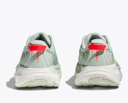 Light green sneakers with red accents on a white background