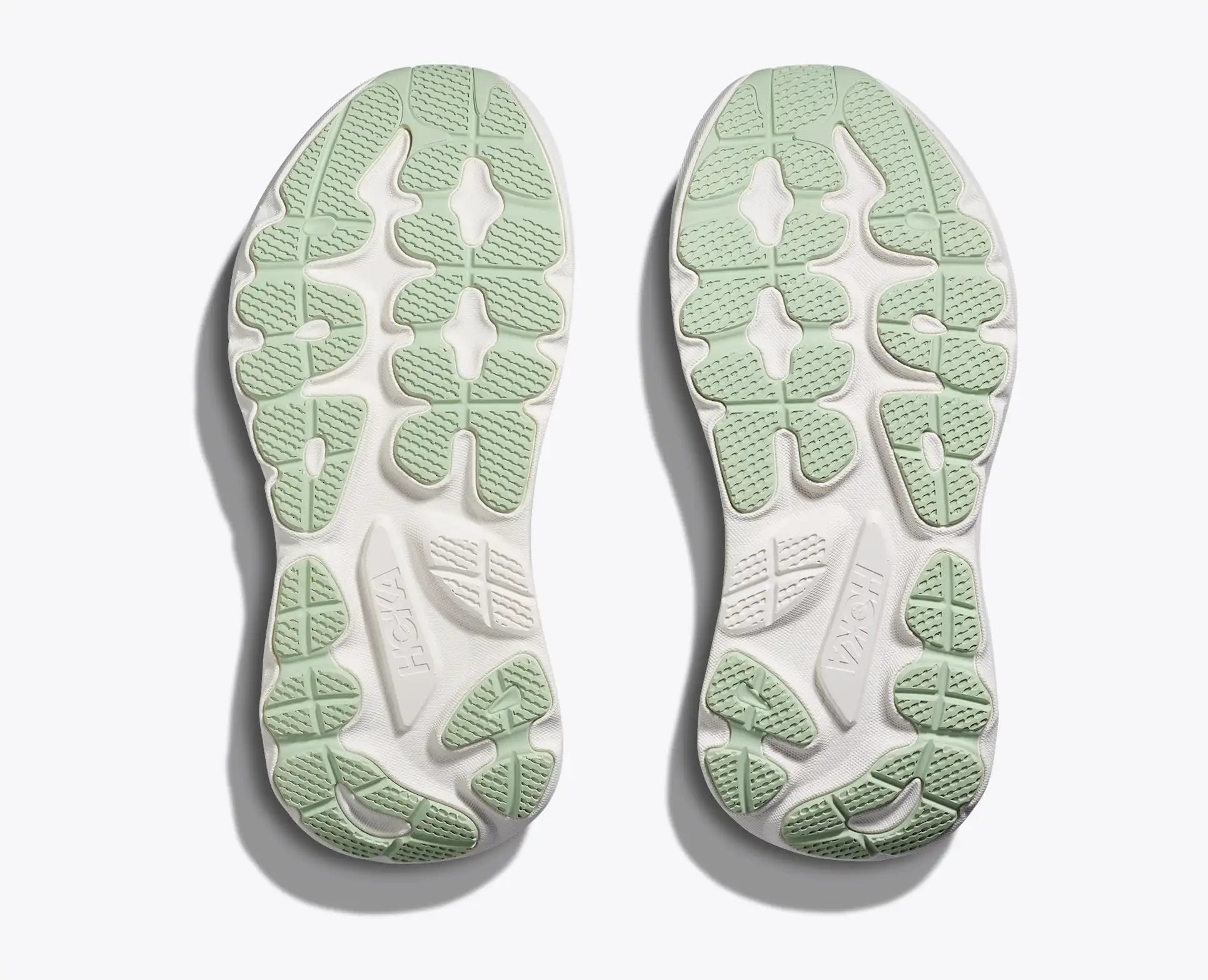 Green and white sole of a shoe on a light gray background