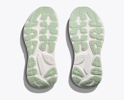 Green and white sole of a shoe on a light gray background