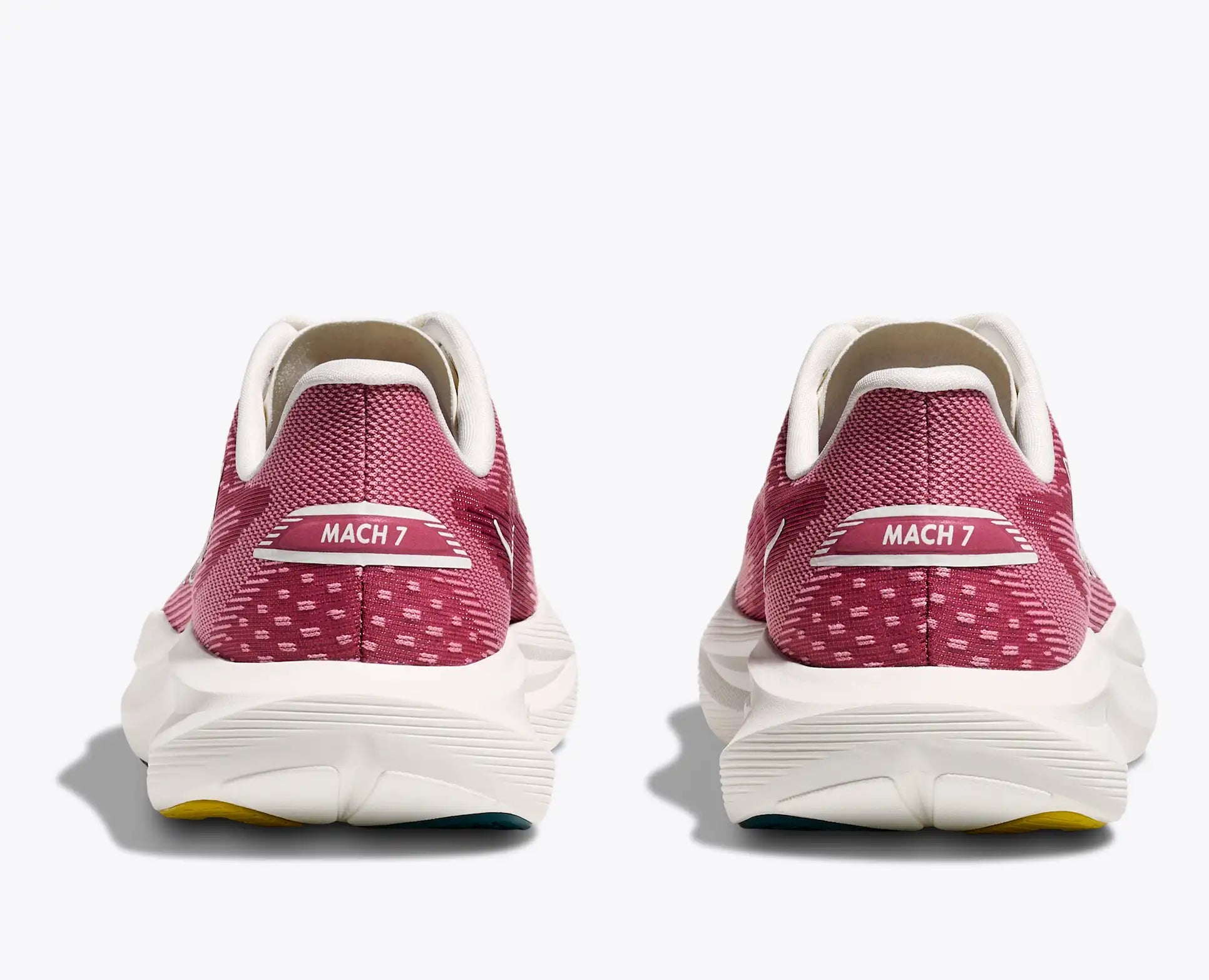 Pink running shoes with 'MACH 7' label on a white background