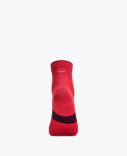 A single red athletic crew sock shown from the back on a light gray background, featuring a dark red heel section and a small white logo near the cuff.