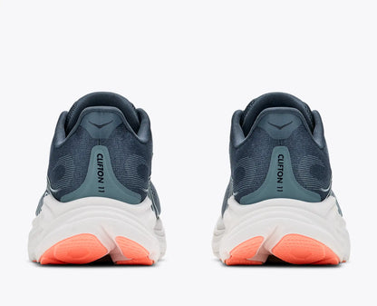A pair of running shoes shown from the rear, featuring a dark slate blue and teal upper, a thick white midsole, and bright coral orange outsoles, on a light gray background.